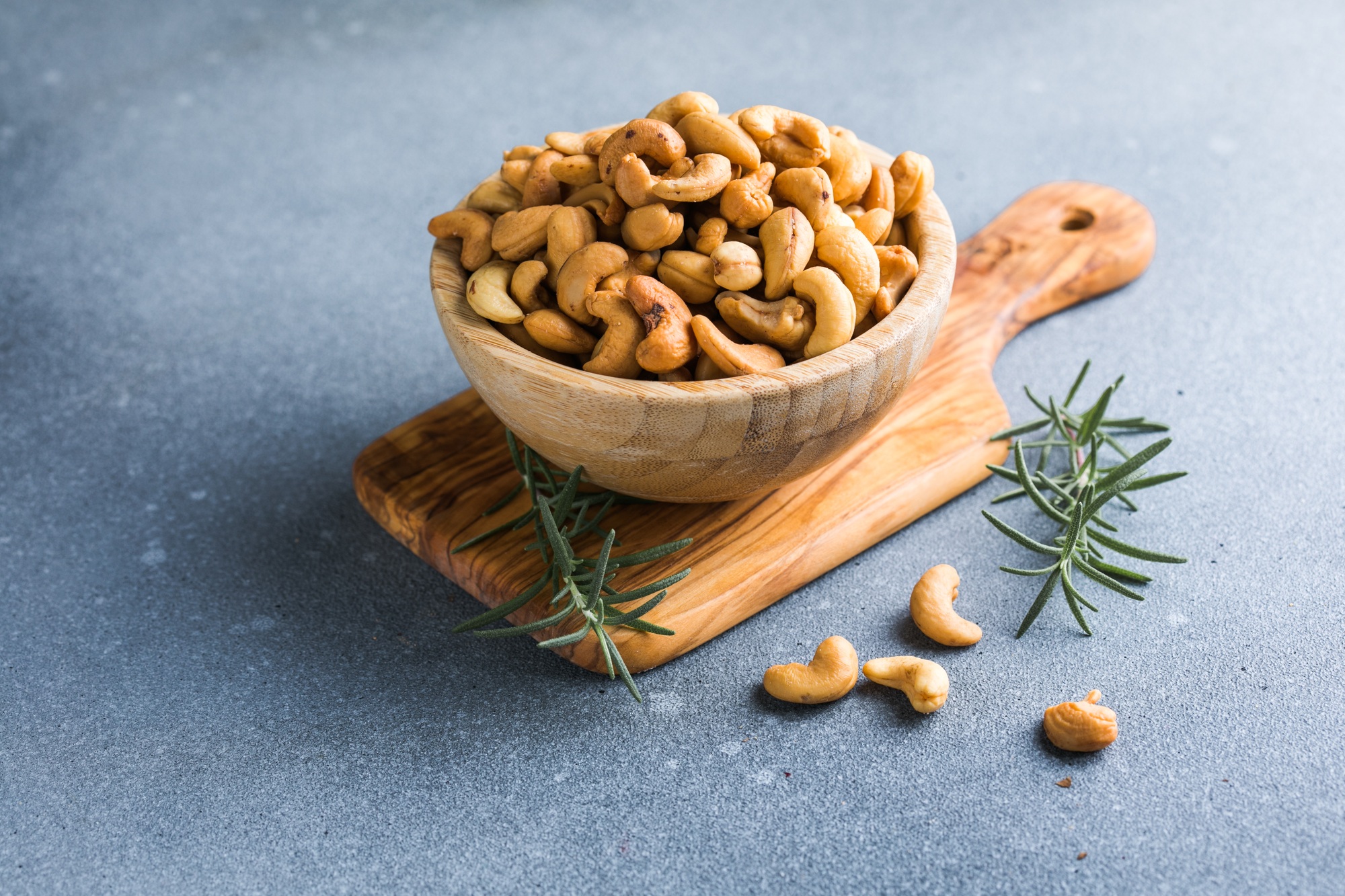 wooden plate filled with cashew nuts